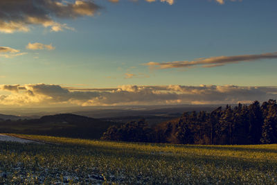 Scenic view of field against sky during sunset