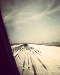 Snow covered landscape against sky