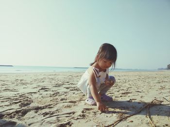 Full length of girl on beach against clear sky