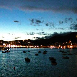 Boats in sea at dusk