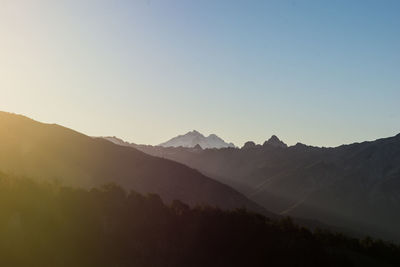 Scenic view of silhouette mountains against clear sky
