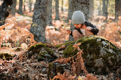 Man standing on rock in forest