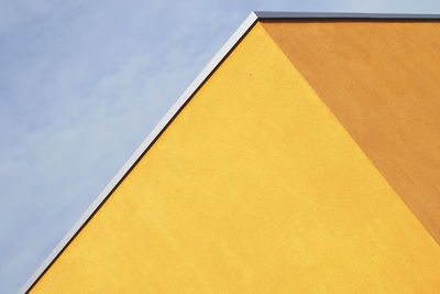 Low angle view of yellow building against sky