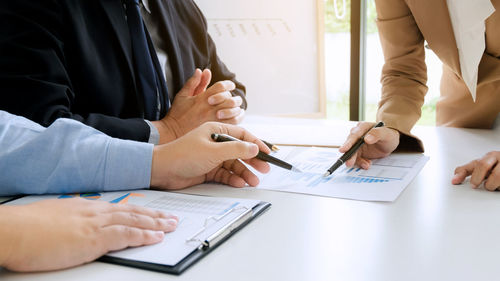 Close-up of people working in pen