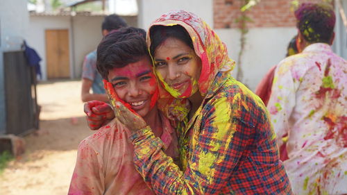 Happy mother enjoying time with her son during holi festival at home