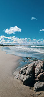 Scenic view of beach against blue sky