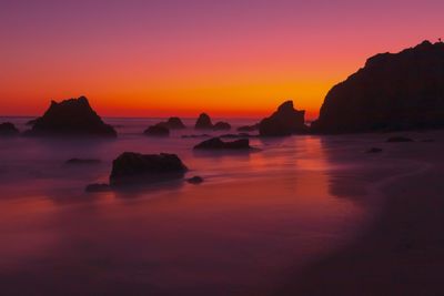Scenic view of sea against sky during sunset with arch formation