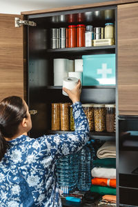 Side view of woman sitting on table