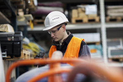 Technician male with helmet working in a store