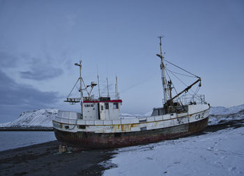 Fishing boat in sea against sky