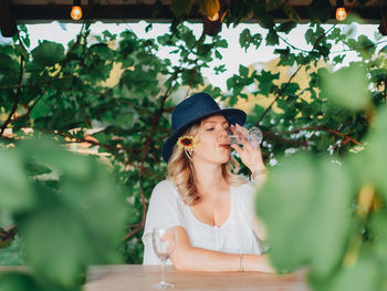 Portrait of young woman wearing hat