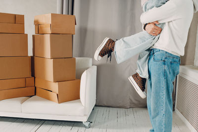 Rear view of woman sitting on sofa at home