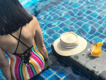 Rear view of person wearing hat in swimming pool