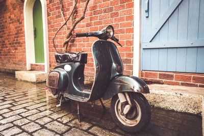 Bicycle against brick wall of building