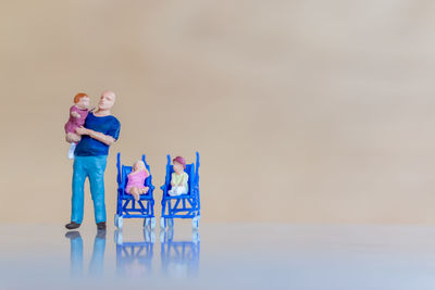 Rear view of people standing on table against sky