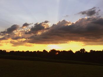 Scenic view of landscape against sky at sunset