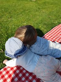 Rear view of father and daughter on field
