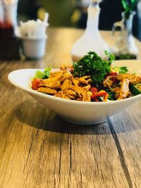 Close-up of meat served in bowl on wooden table