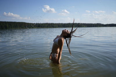 Full length of shirtless man in lake