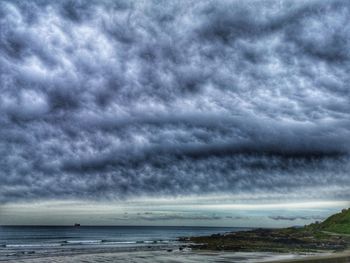 Scenic view of sea against dramatic sky