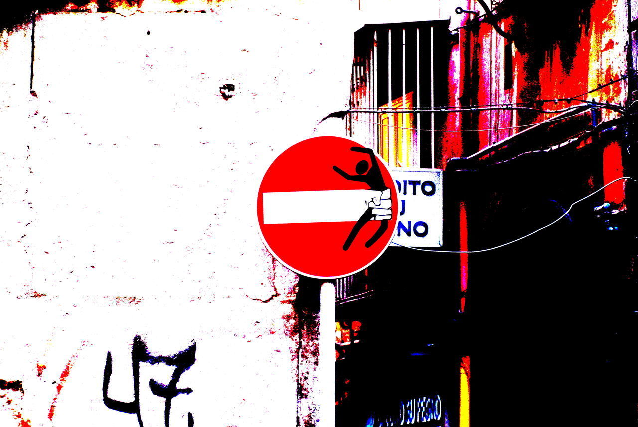 ROAD SIGN AGAINST WALL