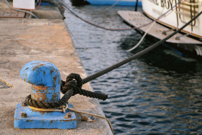 Rope tied to bollard on pier