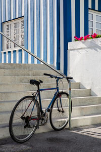 Bicycle on sidewalk against building