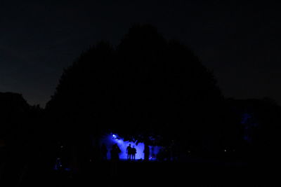 Silhouette buildings against sky at night