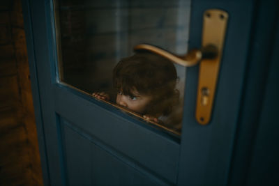 Cute girl peeking through window