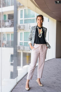 Portrait of a smiling young woman standing outdoors