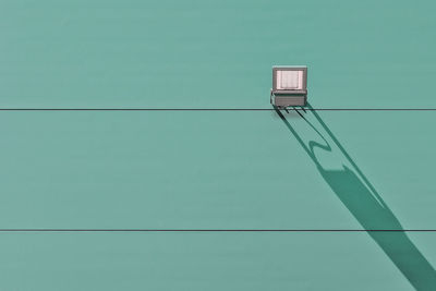 Low angle view of floodlight against wall
