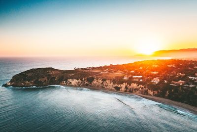 Scenic view of sea against clear sky during sunset