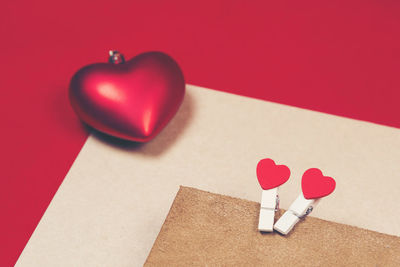 High angle view of heart shape on red table