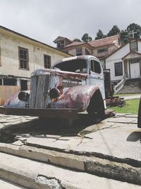 Abandoned car against sky