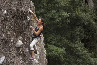 One woman concentrated holds herself while rock climbing in jilotepec