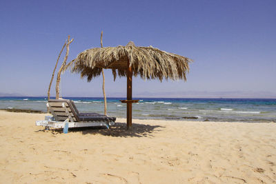 Lifeguard hut on beach against clear sky