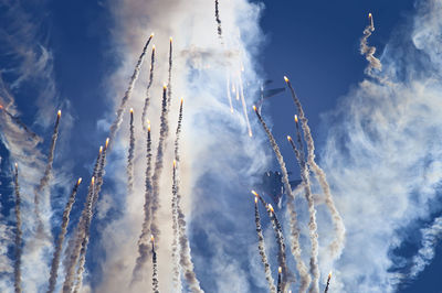 Low angle view of fireworks exploding against sky