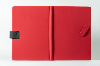 Close-up of red open book against white background