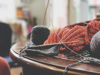 Close-up of crochets on wooden table