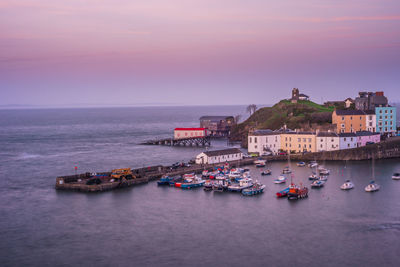 View of boats in sea at sunset