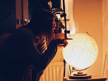 Side view of a man holding woman at home