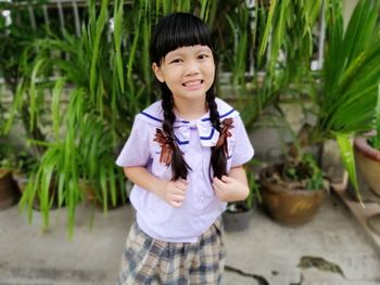 Portrait of cute girl standing outdoors