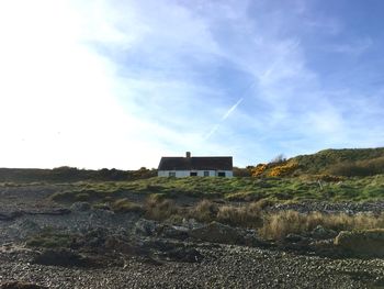 Houses on landscape against sky