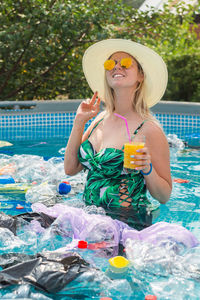 Woman wearing hat holding swimming pool