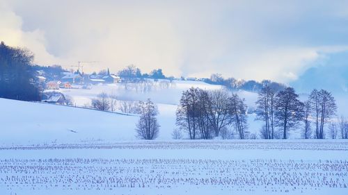 Snow covered field against sky