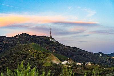 Scenic view of mountains and buildings against sky