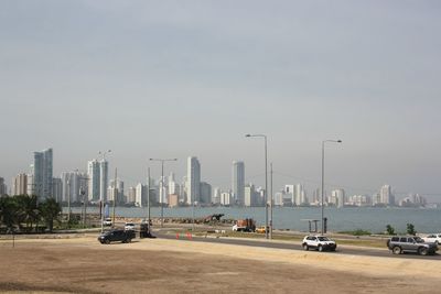 Cars on street against clear sky