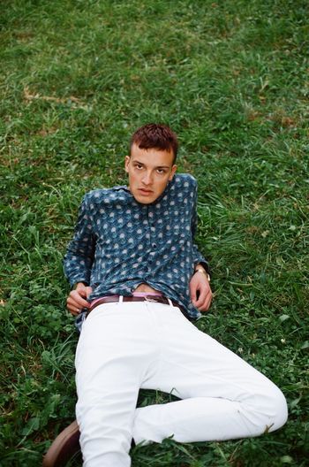 Portrait of young man lying down on land