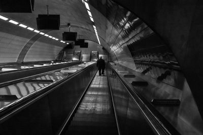 Rear view of man on escalator