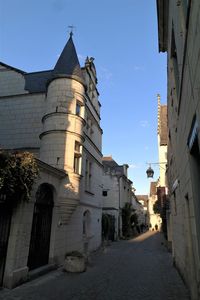 Street amidst buildings against sky in city